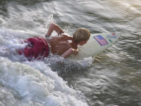 Kid surfing on surf board Sebastian Inlet, Sebastian, Florida