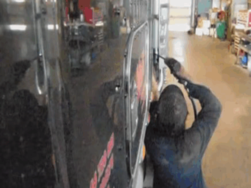 Worker installing new custom chrome exhaust system