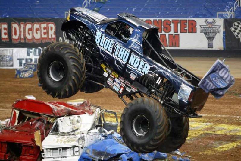 Blue Thunder Monster Truck catching some air in the stadium