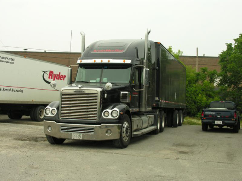 Black Freightliner with pup trailer Arvin Meritor show truck