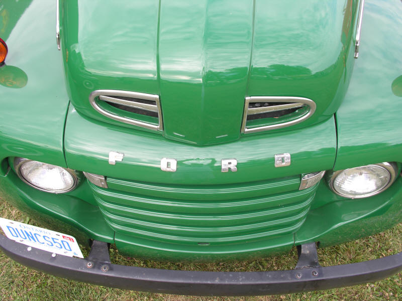 Front and hood of old green Ford pick up truck