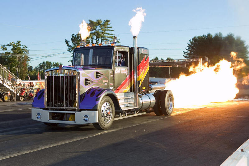 Bob Motz does a little Afterburner flame show prior to his run down the track to warm up the fans