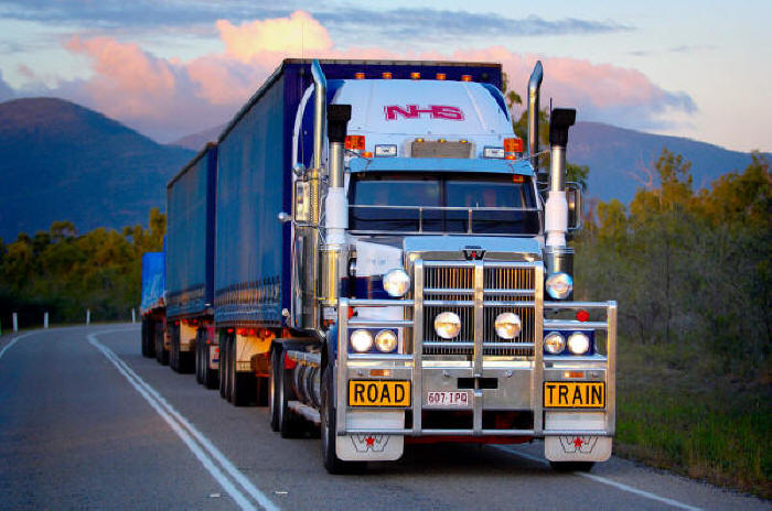 Road Train - Western Star tractor with cattle guard pulling covered wagons